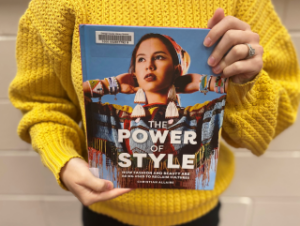 Parseon holding the book 'The Power of Style'