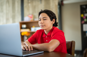 Teen using a laptop