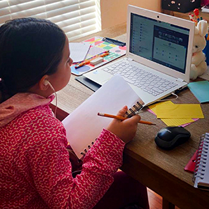 Student doing homework on laptop
