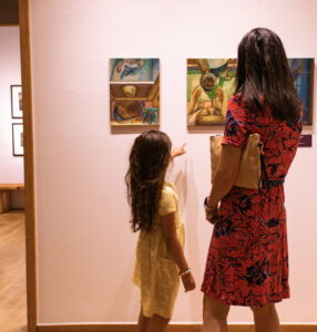 Art & History Center of Maitland. A woman and young girl observing paintings in a gallery.